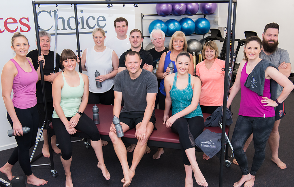 Group of people standing around trapeze table